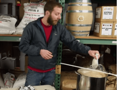 man adding hops in muslin bag